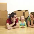 Happy couple with a kid in their new home